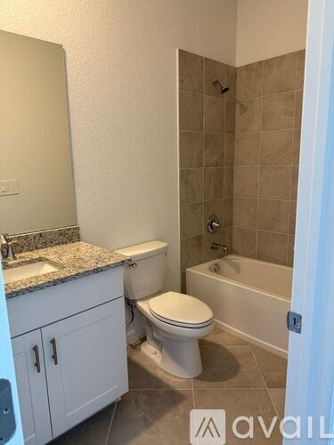 A bathroom with a toilet, sink, and bathtub.