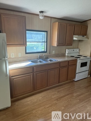 A kitchen with wooden cabinets and a white refrigerator.