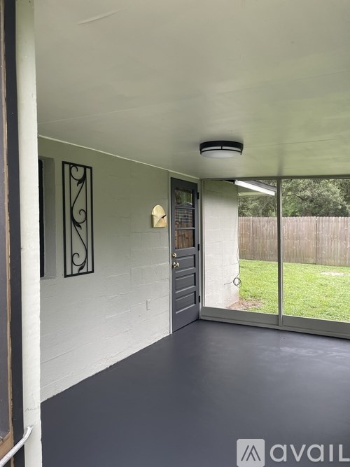 A modern interior with a sliding glass door leading to a backyard.