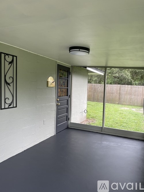 A room with a sliding door and a wall-mounted light fixture.