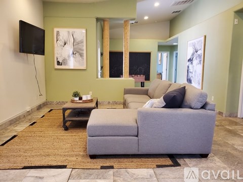 A living room with a grey couch and a coffee table.