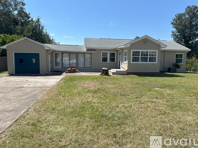 A house with a blue door and a grey roof.