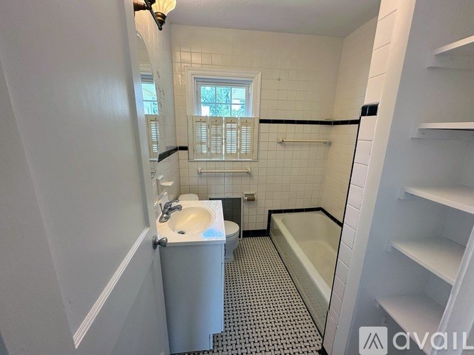 A bathroom with a toilet, sink, and bathtub.