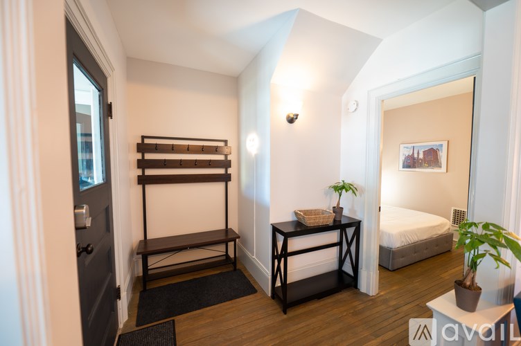 A room with a bed, a table, and a bench.