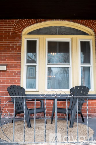 Two black chairs are placed on a patio table.