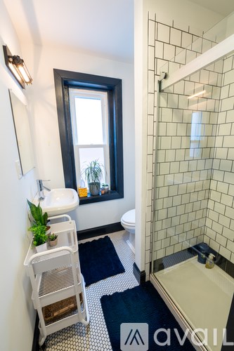 A bathroom with a white sink and a window.