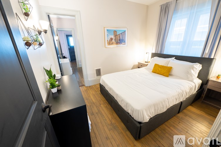 A bedroom with a large bed and a mirror on the wall.