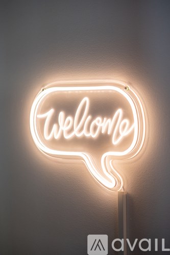 A neon sign that says "Welcome" in a speech bubble shape.