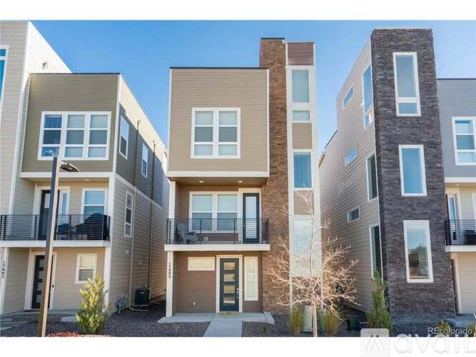 A modern apartment complex with balconies and multiple stories.