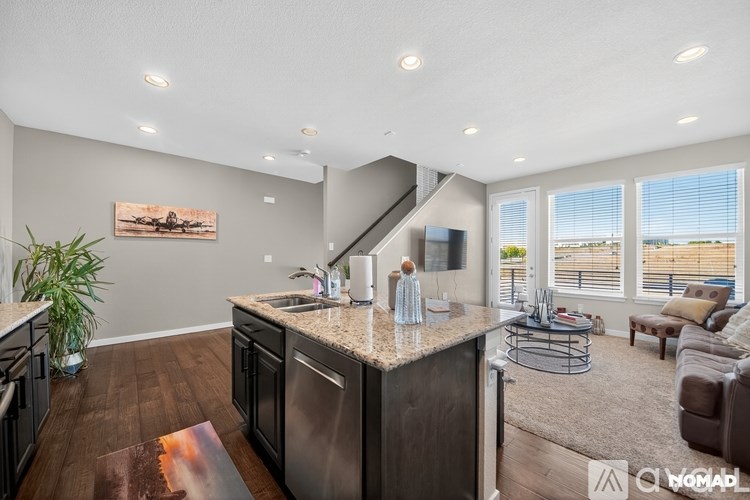 A bathroom with a white toilet, a sink, and a shower.