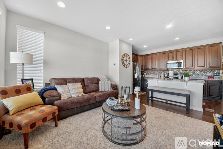 A living room with a brown sofa and a coffee table.