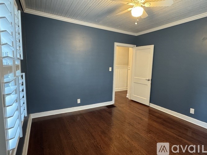 A room with blue walls and a white door.