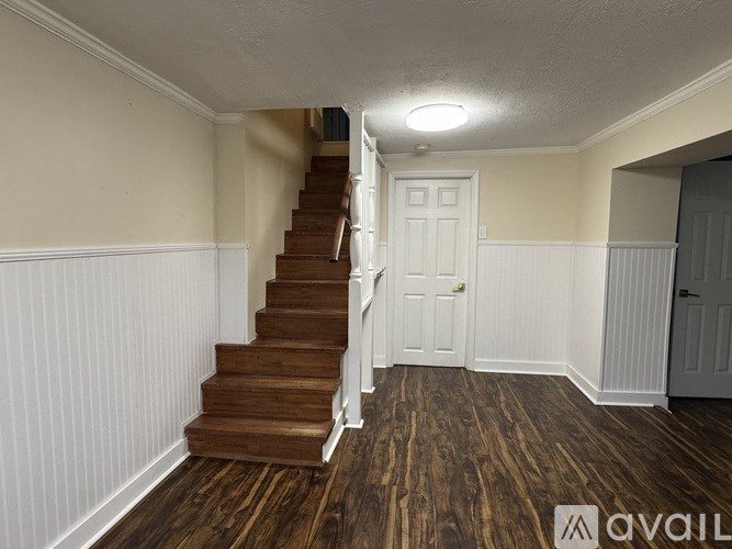 A room with a staircase leading to the upper floor.