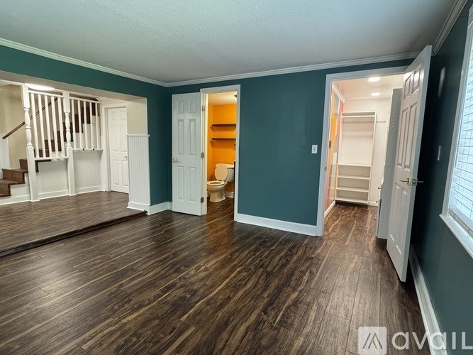 A room with wooden floors and white walls.