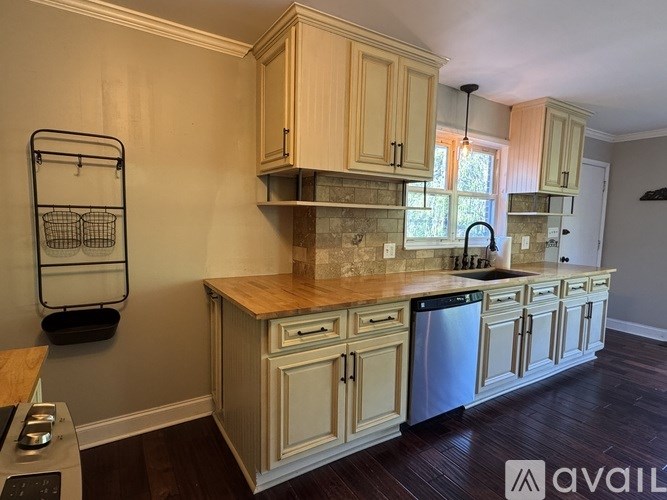 A kitchen with wooden cabinets and a stone countertop.
