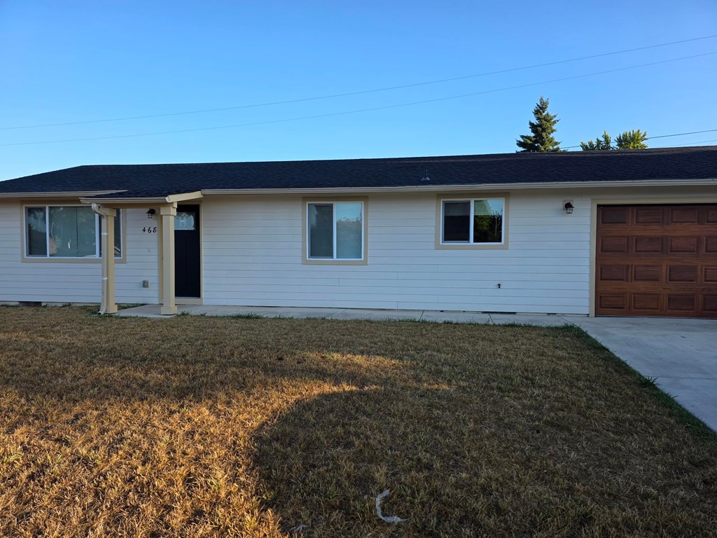 A house with a brown garage door and a black door.