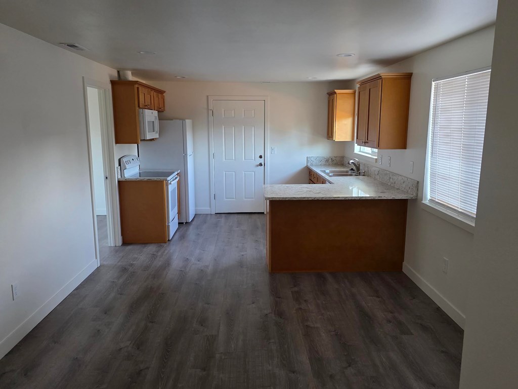 A kitchen with wooden cabinets and a countertop.