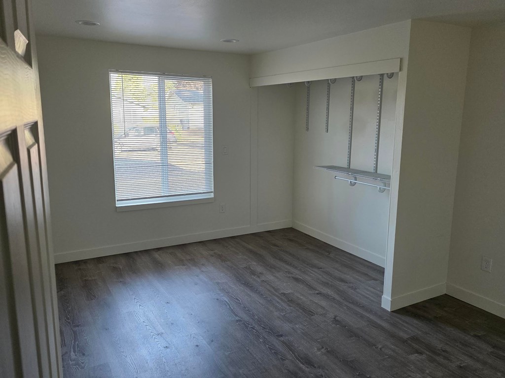 A room with a window and a sliding door.