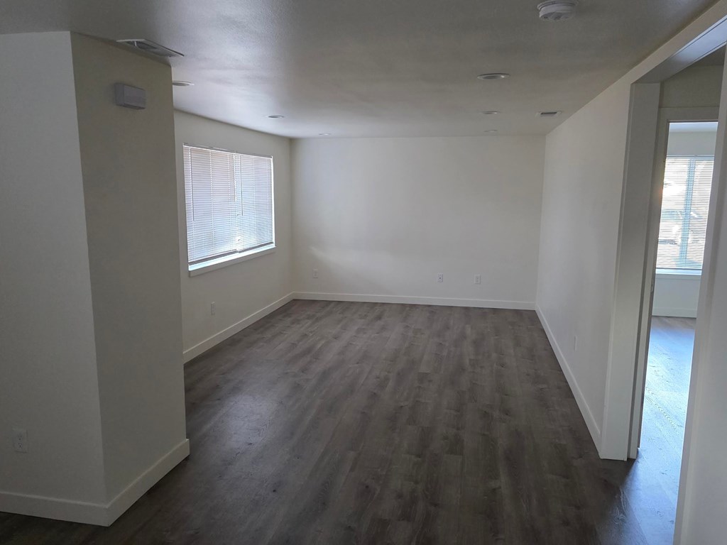 A room with wooden floors and white walls.