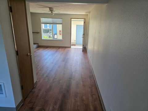 A long hallway with a door on the left and another door on the right.