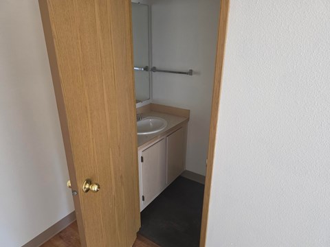 A white sink is in a small bathroom.
