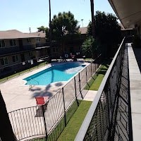 A black fence surrounds a small pool.