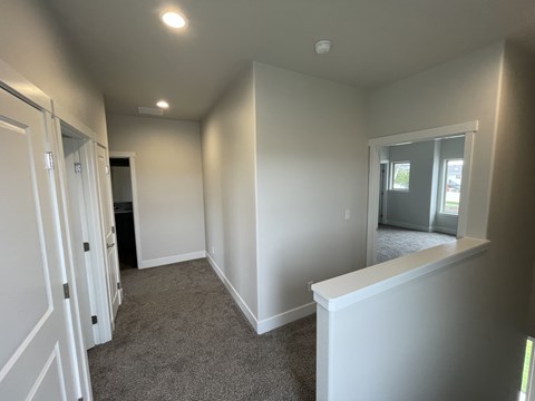 A room with white walls and carpeted floor.