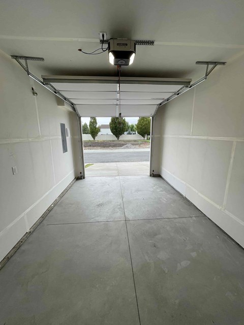 A long white hallway with a light at the end.