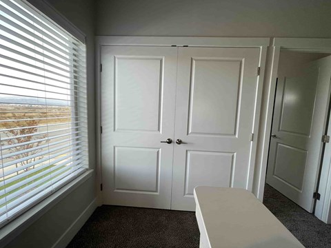 A room with a white table and three white doors.