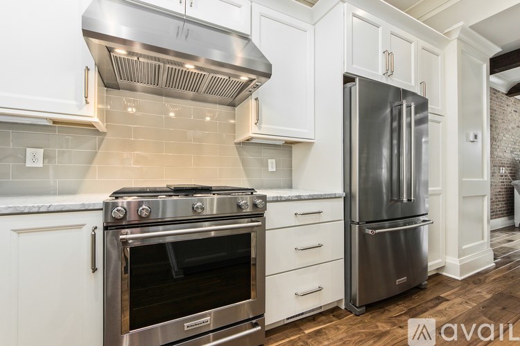 A modern kitchen with a stainless steel oven and refrigerator.