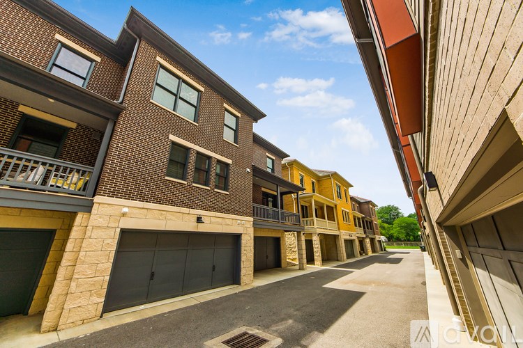 A row of modern townhouses with garages and balconies.