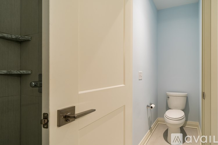 A bathroom with a toilet and a door.