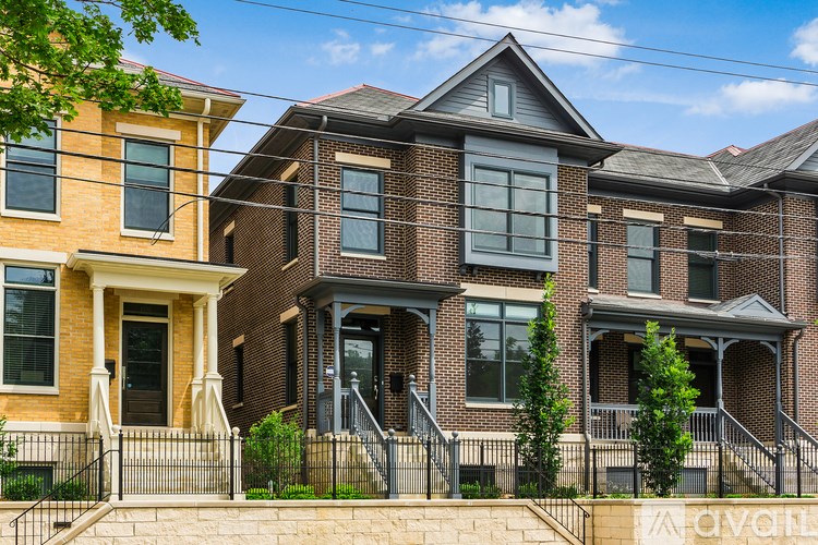 A row of houses with a clear blue sky above them.