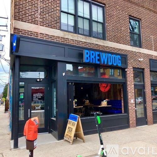 A storefront with a blue sign that says BrewDog.