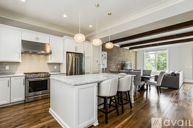 A modern kitchen with a large island and a dining area.