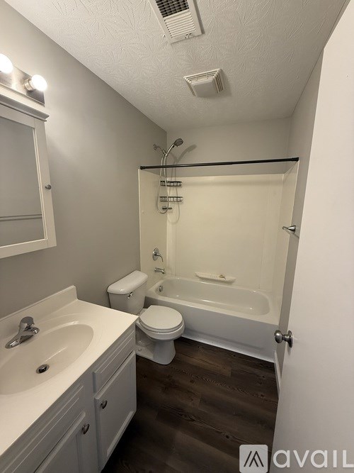 A bathroom with a toilet, sink, and bathtub.