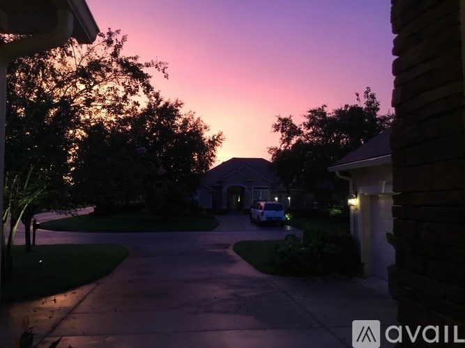 A house is seen with a car parked in front of it.