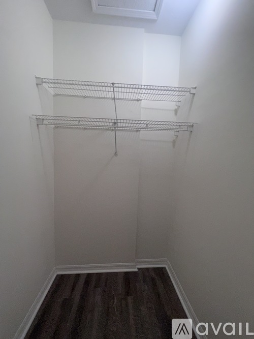 Empty room with shelves and wooden floor.