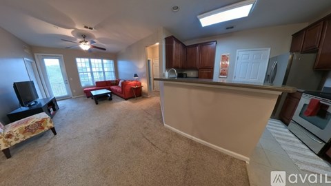 A living room with a red couch and a television.