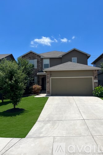 A blue car is parked in front of a house with a driveway.