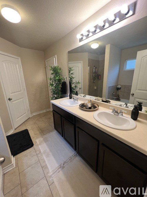 A bathroom with a white sink and a mirror.