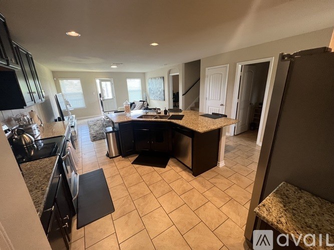 A kitchen with a large island in the middle of the room.