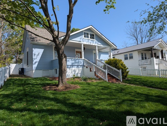A house with a tree in front of it.