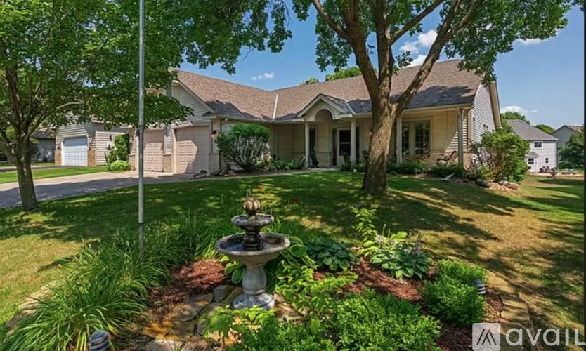 A house with a fountain in the front yard.