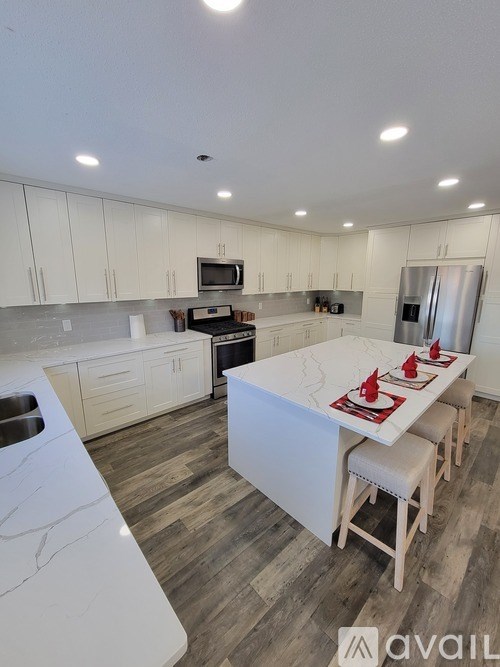 A kitchen with a table and chairs in the middle of it.