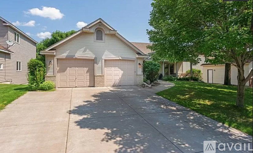 A house with a driveway and garage doors.