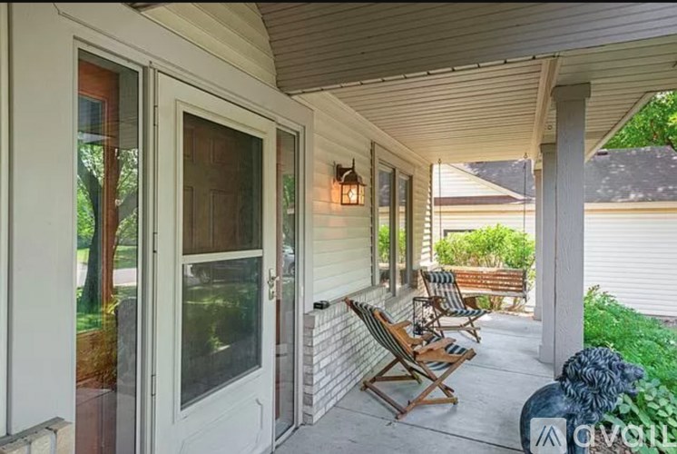 A patio with a bench and chairs is shown.