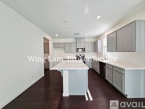 A kitchen with white cabinets and a central island.