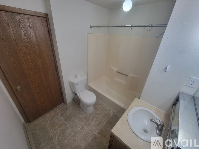 A bathroom with a toilet, sink, and shower.