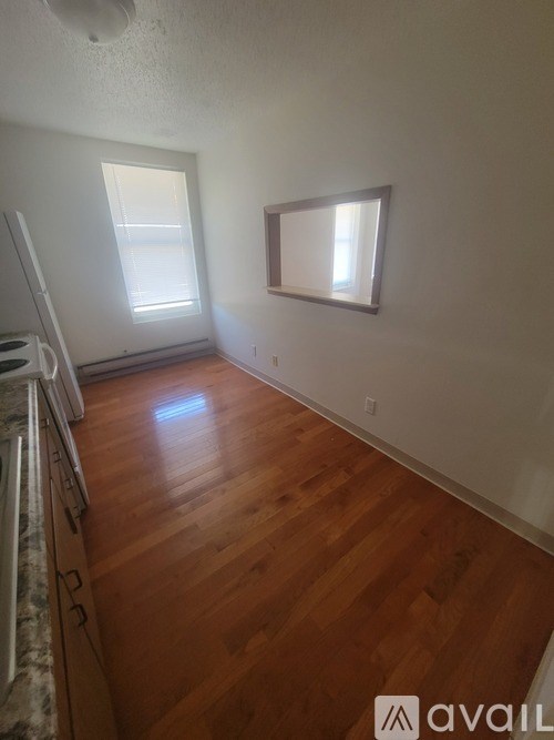 A room with wooden floors and a window.